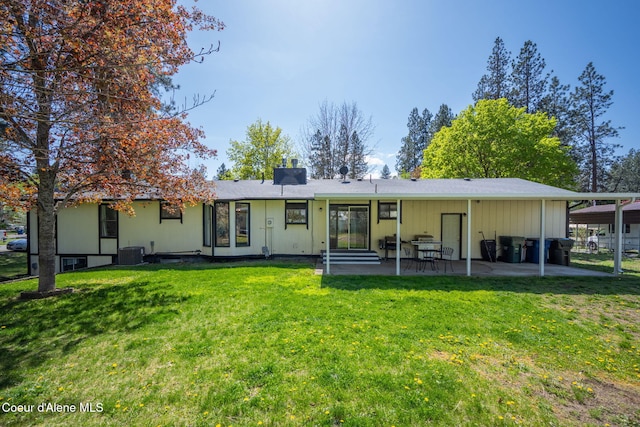 211 S Pinewood Dr, Post Falls, ID 83854 - rear view of house with entry steps, a yard, cooling unit, and a patio area