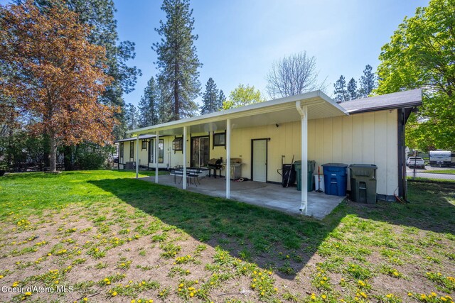 211 S Pinewood Dr, Post Falls, ID 83854 - back of house featuring a yard and a patio area