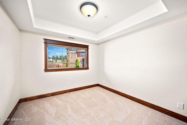 2151 N Main St # 226, Coeur Dalene, ID 83814 - spare room featuring carpet floors, baseboards, a tray ceiling, and visible vents