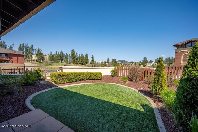 2151 N Main St # 226, Coeur Dalene, ID 83814 - view of yard featuring a fenced backyard and a mountain view