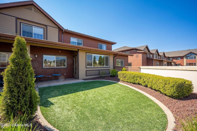 2151 N Main St # 226, Coeur Dalene, ID 83814 - back of house featuring a lawn, a patio area, and fence