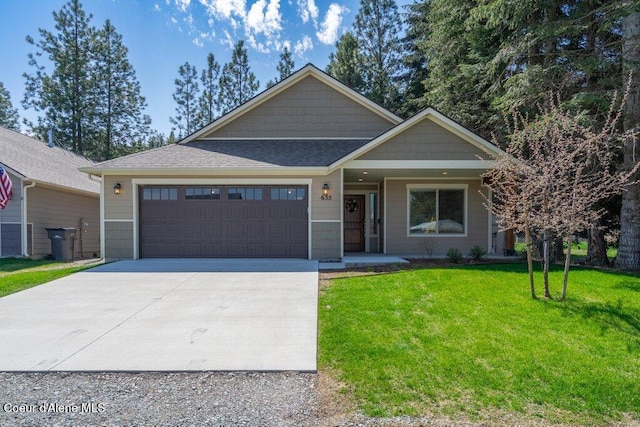 635 E Valley St, Oldtown, ID 83822 - view of front of property with a front lawn, a shingled roof, concrete driveway, an attached garage, and a porch