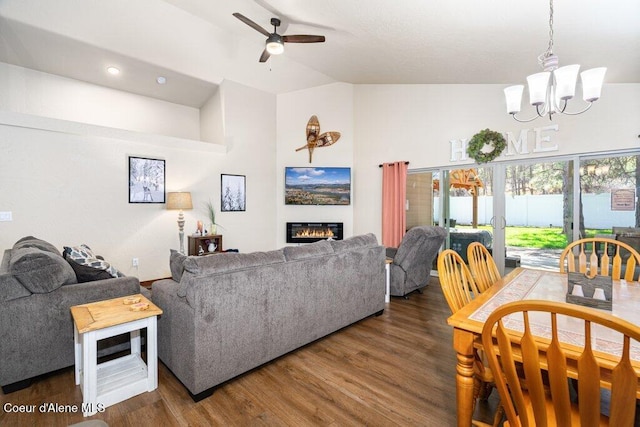 635 E Valley St, Oldtown, ID 83822 - living room featuring a glass covered fireplace, ceiling fan with notable chandelier, wood finished floors, and vaulted ceiling