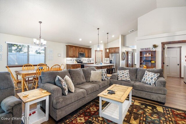 635 E Valley St, Oldtown, ID 83822 - living room featuring visible vents, a notable chandelier, wood finished floors, lofted ceiling, and recessed lighting