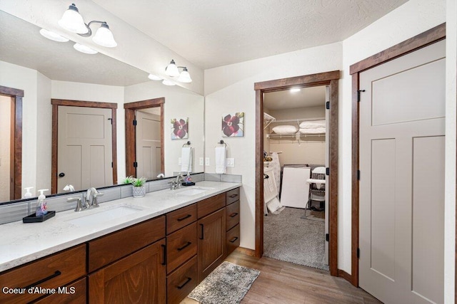 635 E Valley St, Oldtown, ID 83822 - bathroom with double vanity, a sink, and wood finished floors