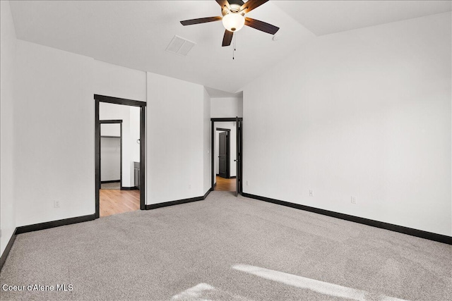 interior space featuring baseboards, ceiling fan, lofted ceiling, and visible vents