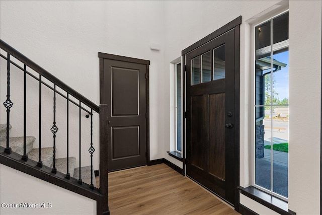 foyer featuring stairway and wood finished floors