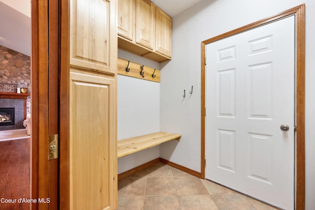 8533 N Tartan Dr, Hayden, ID 83835 - mudroom with a stone fireplace, baseboards, and light tile patterned flooring