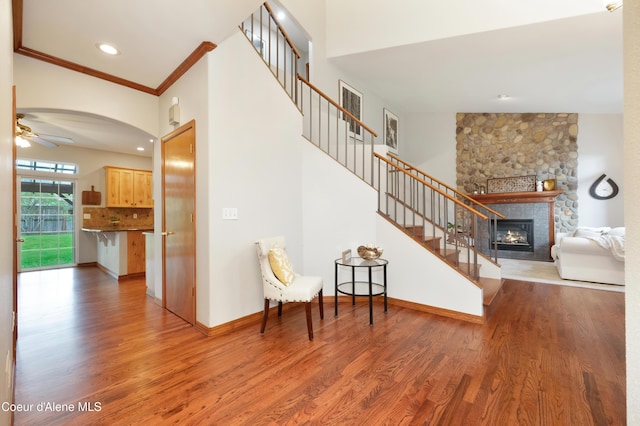8533 N Tartan Dr, Hayden, ID 83835 - stairway featuring wood finished floors, a fireplace, a ceiling fan, crown molding, and recessed lighting