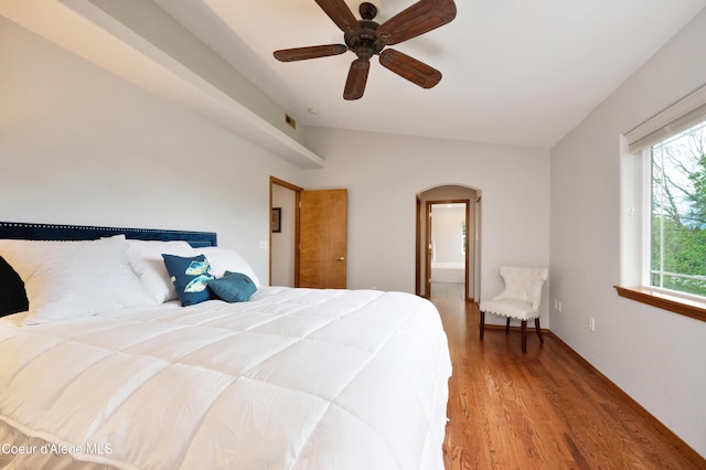8533 N Tartan Dr, Hayden, ID 83835 - bedroom with arched walkways, wood finished floors, and a ceiling fan