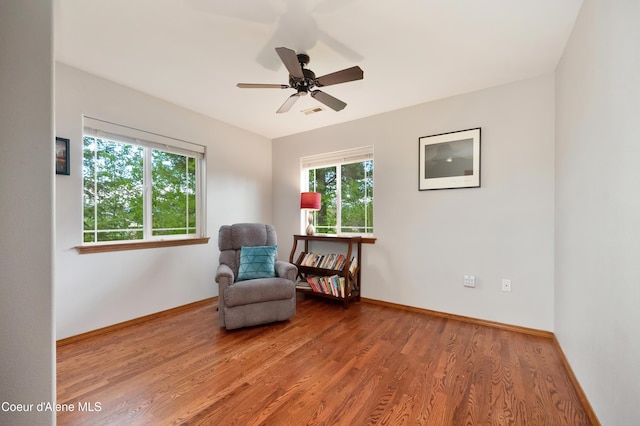 8533 N Tartan Dr, Hayden, ID 83835 - sitting room with healthy amount of natural light, wood finished floors, baseboards, and a ceiling fan
