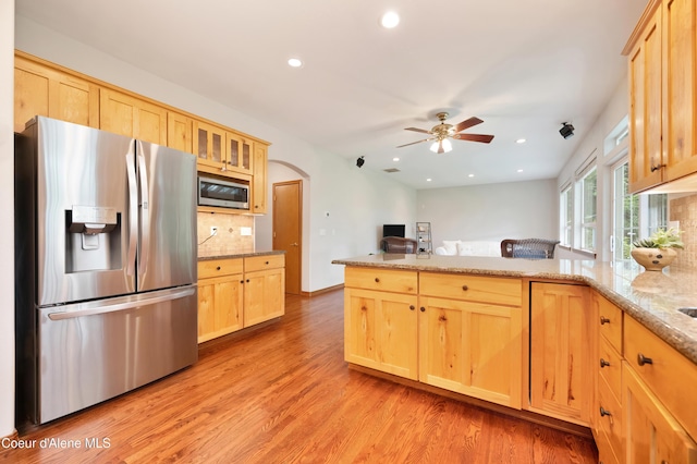 8533 N Tartan Dr, Hayden, ID 83835 - kitchen with appliances with stainless steel finishes, a peninsula, light brown cabinets, tasteful backsplash, and recessed lighting
