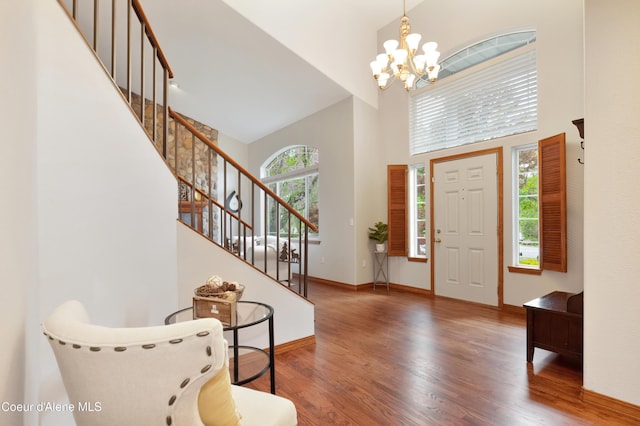8533 N Tartan Dr, Hayden, ID 83835 - foyer featuring a high ceiling, a chandelier, wood finished floors, stairs, and baseboards