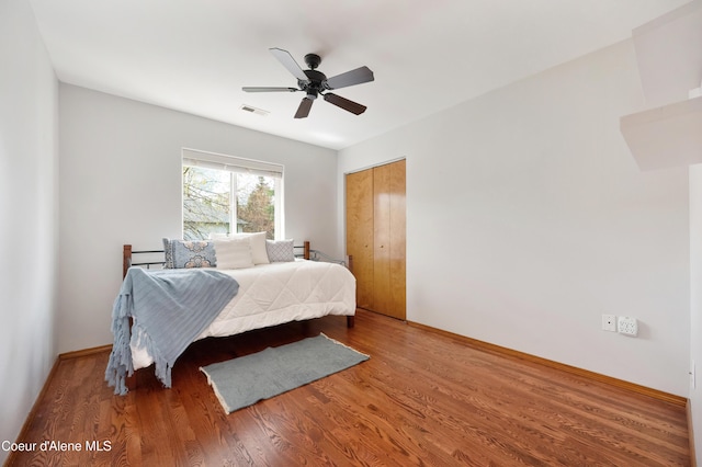 8533 N Tartan Dr, Hayden, ID 83835 - bedroom with wood finished floors, a closet, a ceiling fan, and baseboards