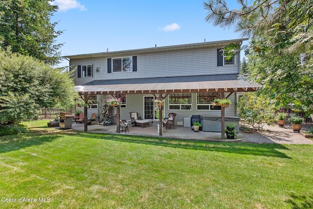 8533 N Tartan Dr, Hayden, ID 83835 - back of property featuring a hot tub and a patio