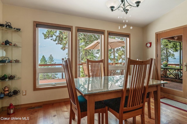 dining room with an inviting chandelier, baseboards, and a healthy amount of sunlight