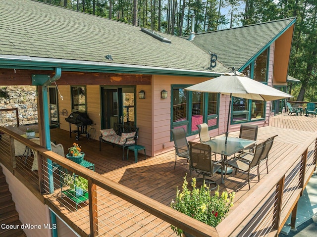 wooden deck featuring outdoor dining area