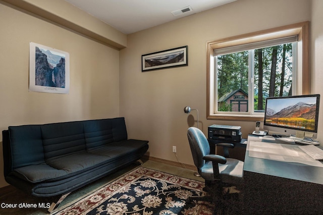 office space featuring baseboards and visible vents