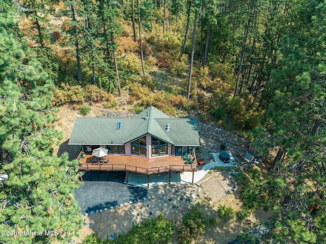 birds eye view of property with a view of trees
