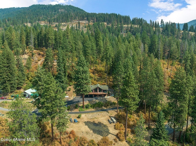 birds eye view of property featuring a mountain view and a forest view