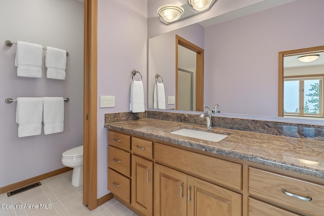 full bath with vanity, toilet, baseboards, an enclosed shower, and visible vents