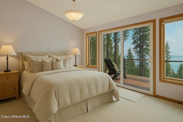 bedroom featuring access to exterior, vaulted ceiling, baseboards, a water view, and light carpet