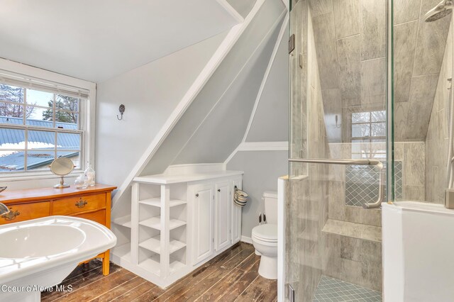 706 Main St, Sandpoint, ID 83864 - full bath featuring toilet, vaulted ceiling, wood finished floors, and a stall shower