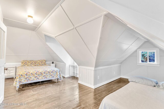 706 Main St, Sandpoint, ID 83864 - bedroom featuring baseboards, lofted ceiling, and hardwood / wood-style flooring