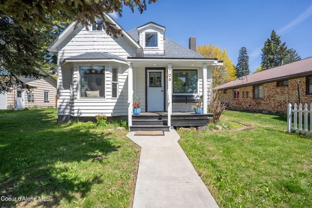 706 Main St, Sandpoint, ID 83864 - bungalow-style home with covered porch, a chimney, and a front yard