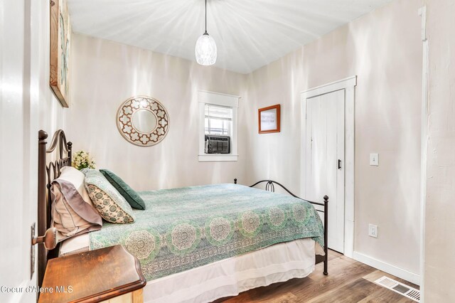 706 Main St, Sandpoint, ID 83864 - bedroom featuring baseboards, visible vents, wood finished floors, and cooling unit