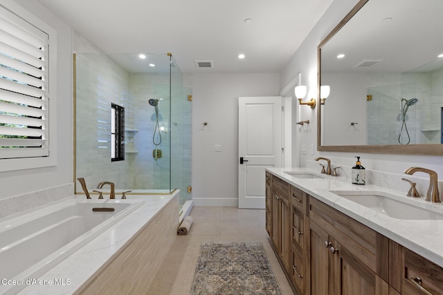 bathroom with a sink, a shower stall, recessed lighting, and visible vents