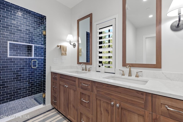 full bathroom with double vanity, a shower stall, and a sink