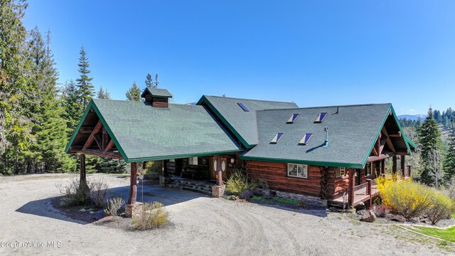 122 Makridge Ln, Kingston, ID 83839 - cabin featuring driveway, log exterior, and a carport