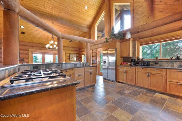 122 Makridge Ln, Kingston, ID 83839 - kitchen featuring dark countertops, plenty of natural light, rustic walls, and stainless steel appliances