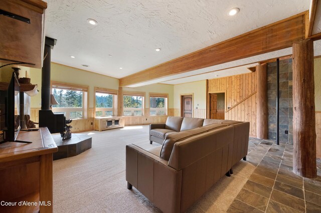 122 Makridge Ln, Kingston, ID 83839 - living area with recessed lighting, wood walls, beam ceiling, and a wood stove