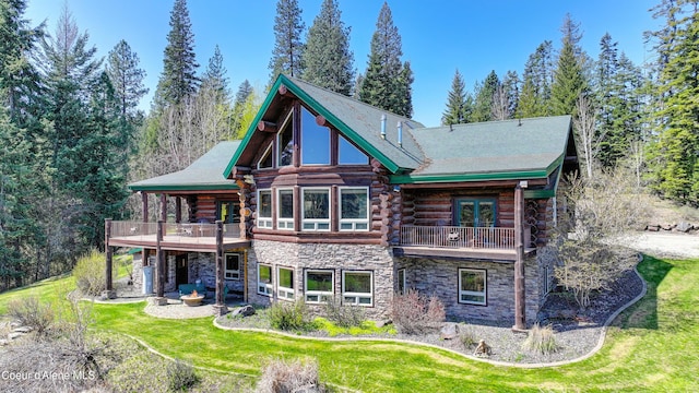 122 Makridge Ln, Kingston, ID 83839 - back of property featuring log exterior, stone siding, and a balcony
