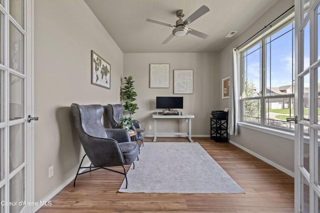 9362 N Prince William Loop, Hayden, ID 83835 - sitting room featuring baseboards, wood finished floors, ceiling fan, and a desk