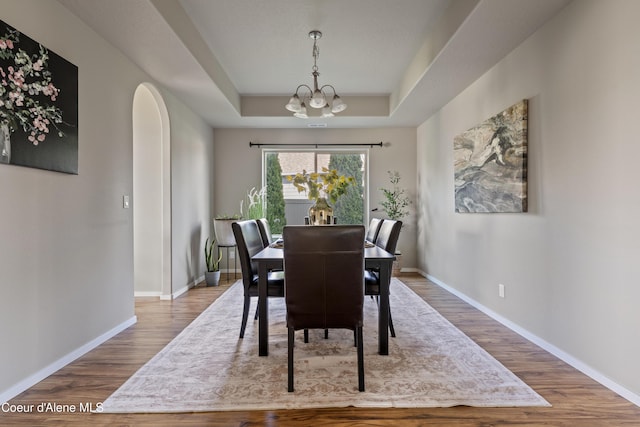 9362 N Prince William Loop, Hayden, ID 83835 - dining space with wood finished floors, a chandelier, baseboards, and a raised ceiling