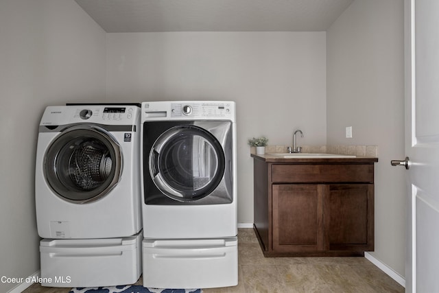 9362 N Prince William Loop, Hayden, ID 83835 - washroom featuring washing machine and clothes dryer, baseboards, and cabinet space