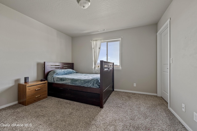9362 N Prince William Loop, Hayden, ID 83835 - bedroom featuring carpet floors, baseboards, and a textured ceiling