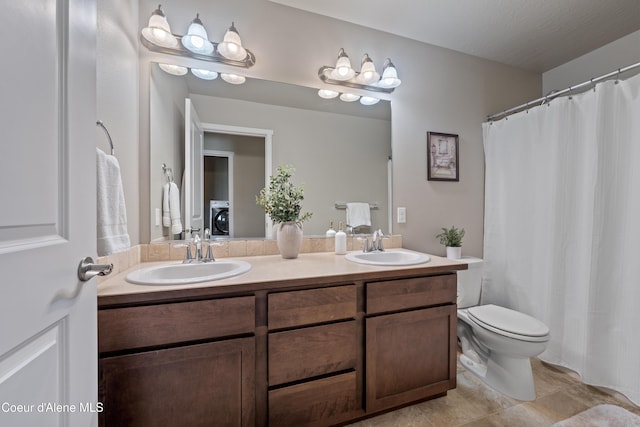 9362 N Prince William Loop, Hayden, ID 83835 - full bath with double vanity, washer / clothes dryer, toilet, and tile patterned floors