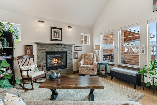 17 Hitchcock Dr, Dover, ID 83825 - sitting room featuring wood finished floors, a fireplace, and high vaulted ceiling