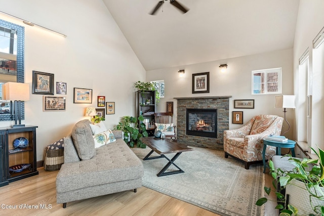 17 Hitchcock Dr, Dover, ID 83825 - living room with healthy amount of natural light, wood finished floors, a fireplace, high vaulted ceiling, and a ceiling fan