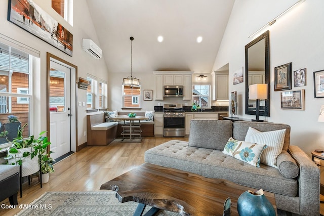 17 Hitchcock Dr, Dover, ID 83825 - living area with high vaulted ceiling, a wall mounted AC, light wood-type flooring, and recessed lighting