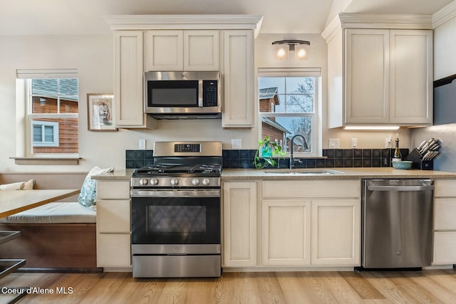 17 Hitchcock Dr, Dover, ID 83825 - kitchen featuring stainless steel appliances, a sink, plenty of natural light, and cream cabinetry