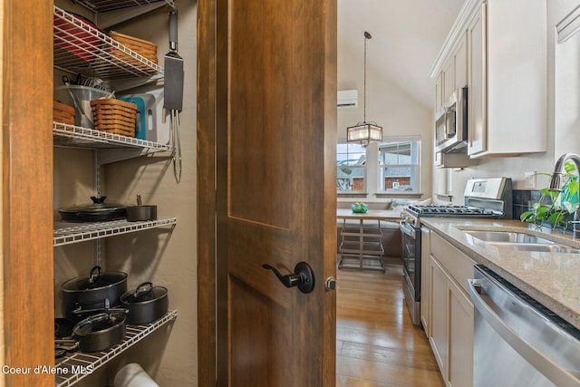 17 Hitchcock Dr, Dover, ID 83825 - kitchen featuring stainless steel appliances, a sink, white cabinets, light stone countertops, and light wood finished floors