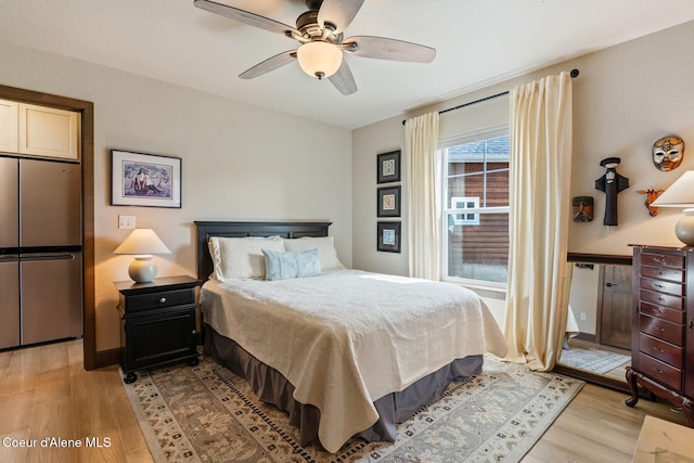17 Hitchcock Dr, Dover, ID 83825 - bedroom featuring stainless steel fridge, light wood-style floors, and ceiling fan
