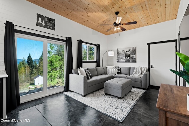 247 Living Waters Way, Priest River, ID 83856 - living area featuring a ceiling fan, wood ceiling, concrete flooring, and vaulted ceiling