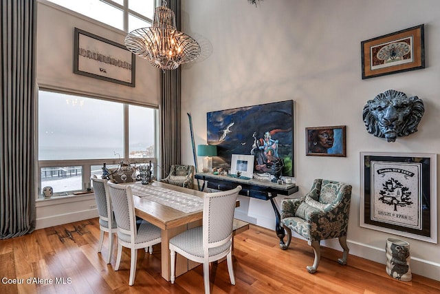 412 Sandpoint Ave Unit 332, Sandpoint, ID 83864 - dining space featuring baseboards, wood finished floors, and a notable chandelier