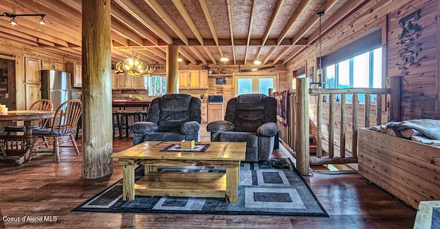 living area featuring an inviting chandelier, plenty of natural light, and dark wood-type flooring